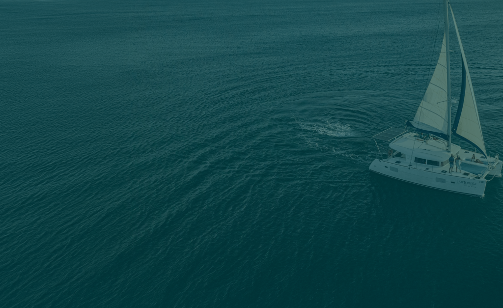 Sailboat on open sea under clear skies during daytime.