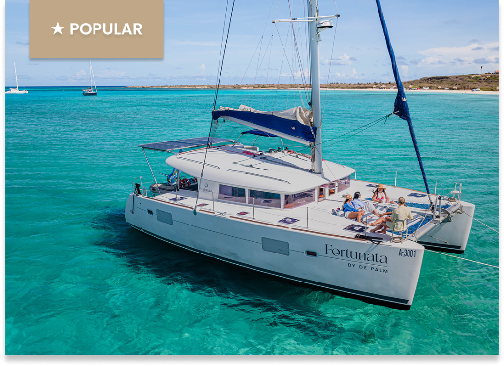 Sailing catamaran with people onboard in clear turquoise water, labeled 'POPULAR'.